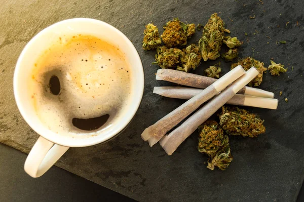 Coffee cup with pre-rolls and flower